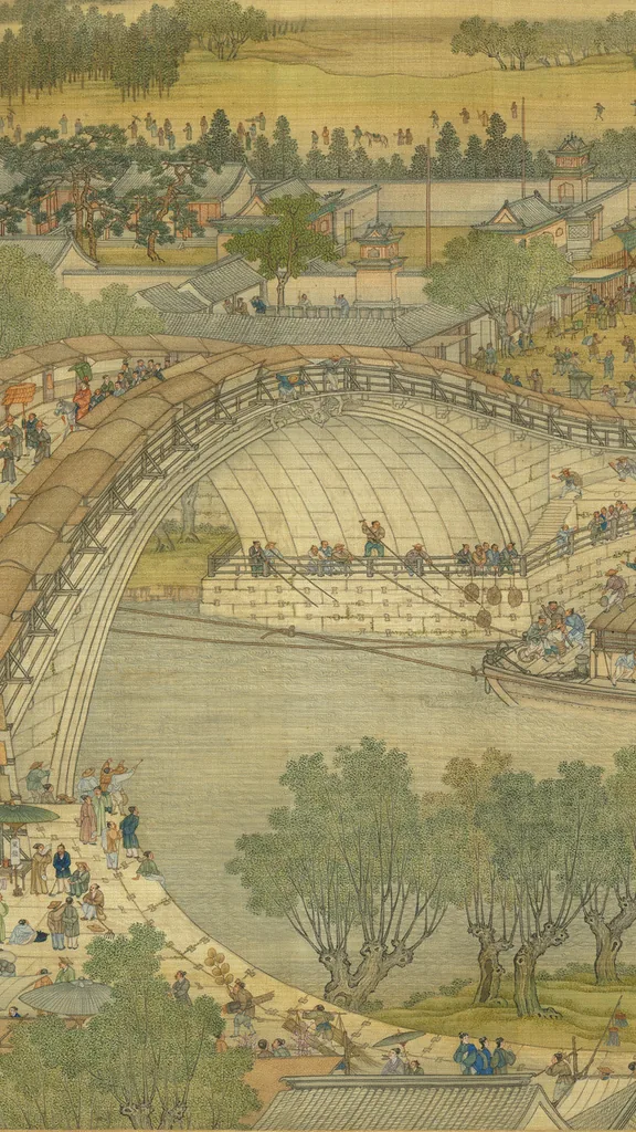 The rainbow bridge of the Qing court Qingming scroll: a crowd on the white stone arch, boats on the river beneath it, green trees and shop roofs, in colour on pale silk